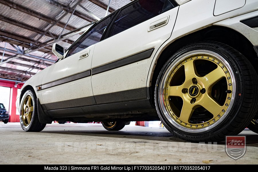 17x7.0 17x8.5 Simmons FR-1 Gold on Mazda 323 (1993)
