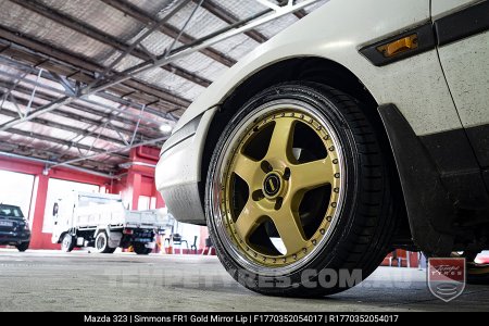17x7.0 17x8.5 Simmons FR-1 Gold on Mazda 323 (1993)